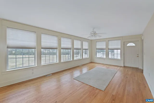 a view of a dining room with furniture a livingroom and wooden floor
