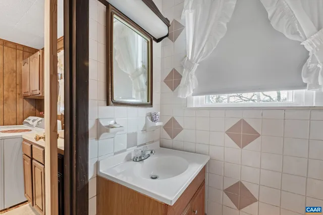 a bedroom with a chandelier and ceiling fan