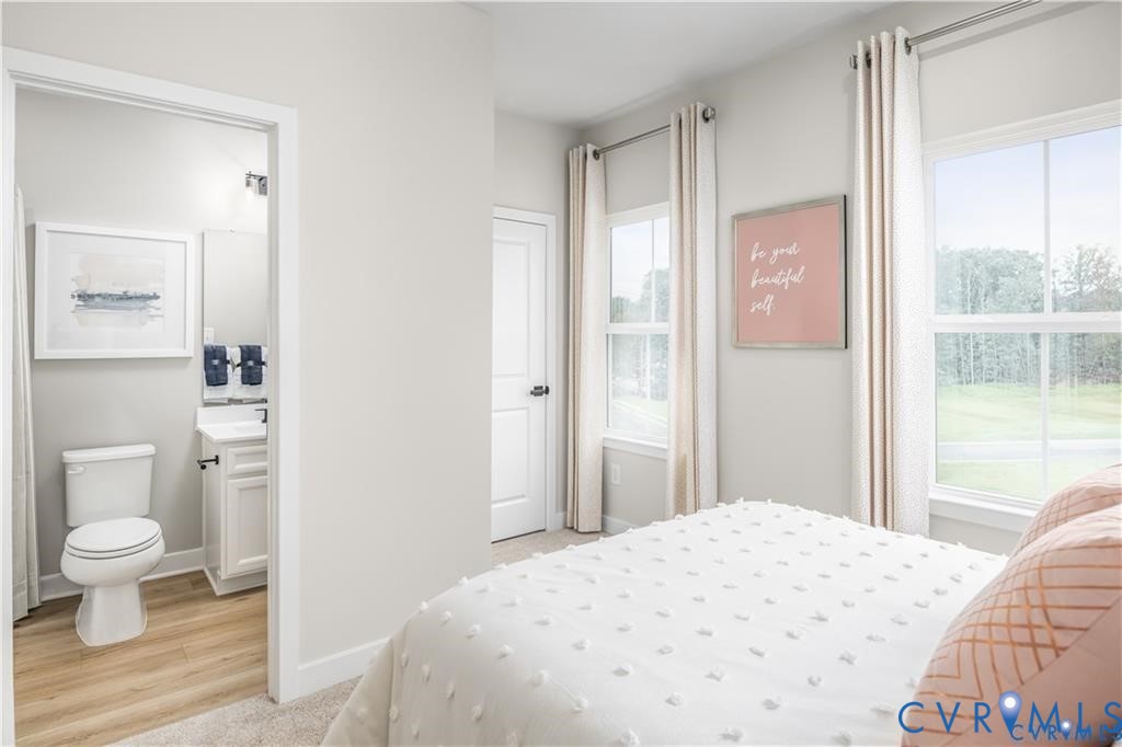 12705 Red Clover Way Midlothian, VA 23112 - Photo 19 of 27 a bedroom with a bed and a potted plant