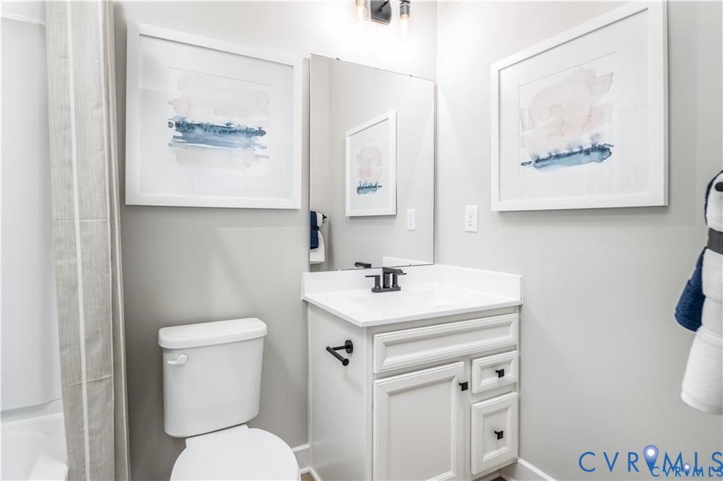 12705 Red Clover Way Midlothian, VA 23112 - Photo 20 of 27 a bathroom with a toilet sink and mirror