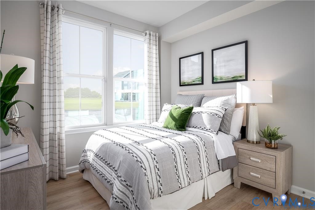 12705 Red Clover Way Midlothian, VA 23112 - Photo 23 of 27 a bedroom with a bed lamp and windows