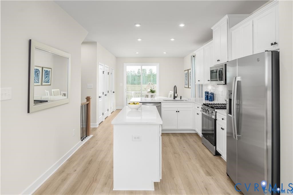 12705 Red Clover Way Midlothian, VA 23112 - Photo 10 of 27 a kitchen with white cabinets and stainless steel appliances