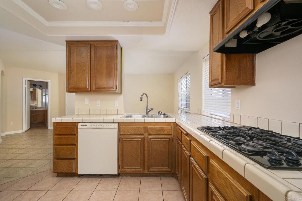 1744 Via Allena Oceanside, CA 92056 - Photo 11 of 36 a kitchen with stainless steel appliances a stove a sink and a microwave