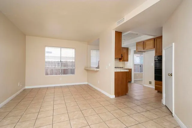 a view of a kitchen with a refrigerator and a sink
