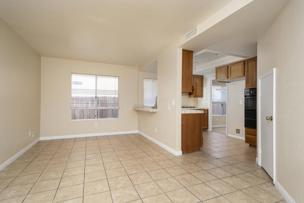 1744 Via Allena Oceanside, CA 92056 - Photo 14 of 36 a view of a kitchen with a refrigerator and a sink