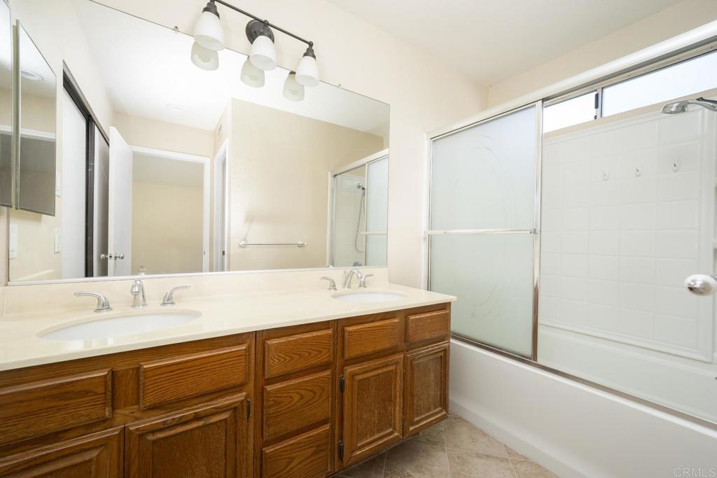 1744 Via Allena Oceanside, CA 92056 - Photo 17 of 36 a bathroom with a double vanity sink mirror and shower