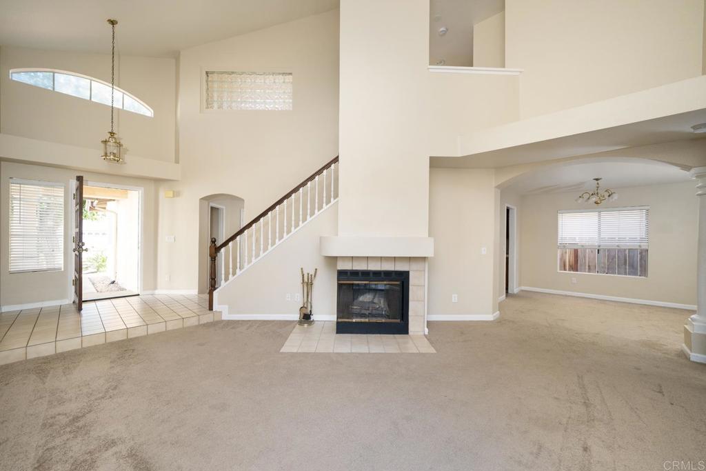 1744 Via Allena Oceanside, CA 92056 - Photo 4 of 36 a view of an empty room with a fireplace and a window