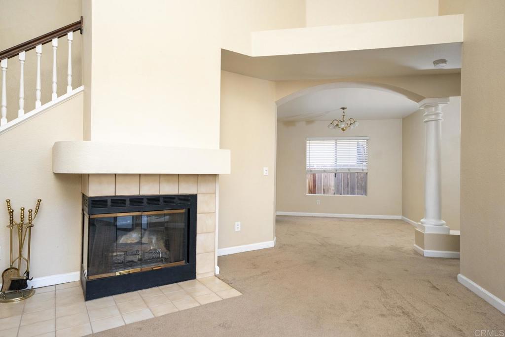 1744 Via Allena Oceanside, CA 92056 - Photo 8 of 36 a view of an empty room with fireplace and a window