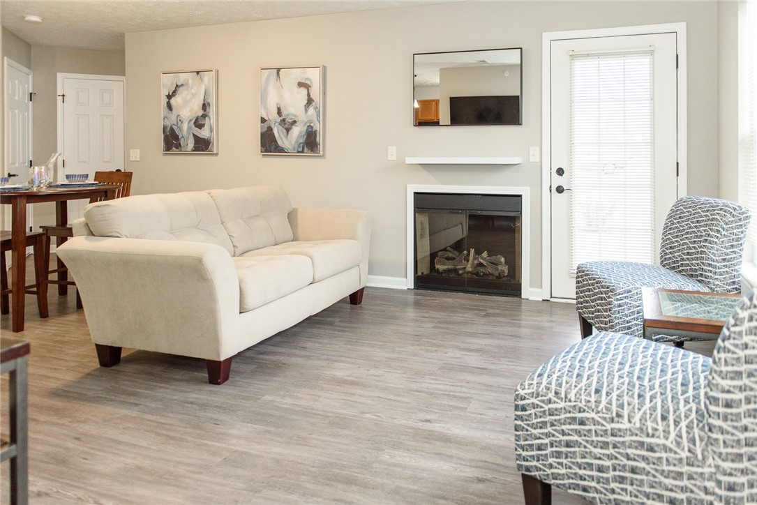 1260 Lehigh Station Road, Unit 408 Henrietta, NY 14467 - Photo 2 of 14 Typical Great Room with Fireplace, Living, Dining