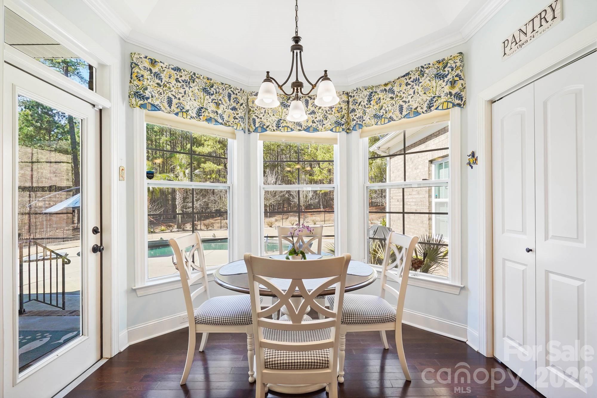 5312 Johnsons Barn Road York, SC 29745 - Photo 18 of 46 a dining room with furniture a chandelier and wooden floor