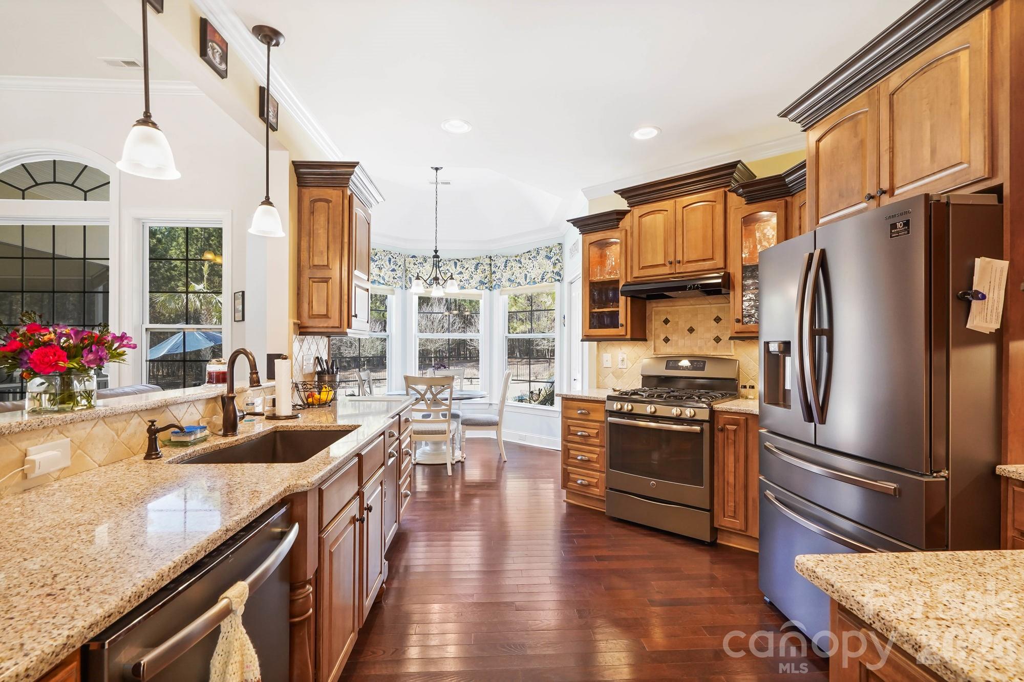 5312 Johnsons Barn Road York, SC 29745 - Photo 20 of 46 a kitchen with stainless steel appliances granite countertop a refrigerator a stove and a sink