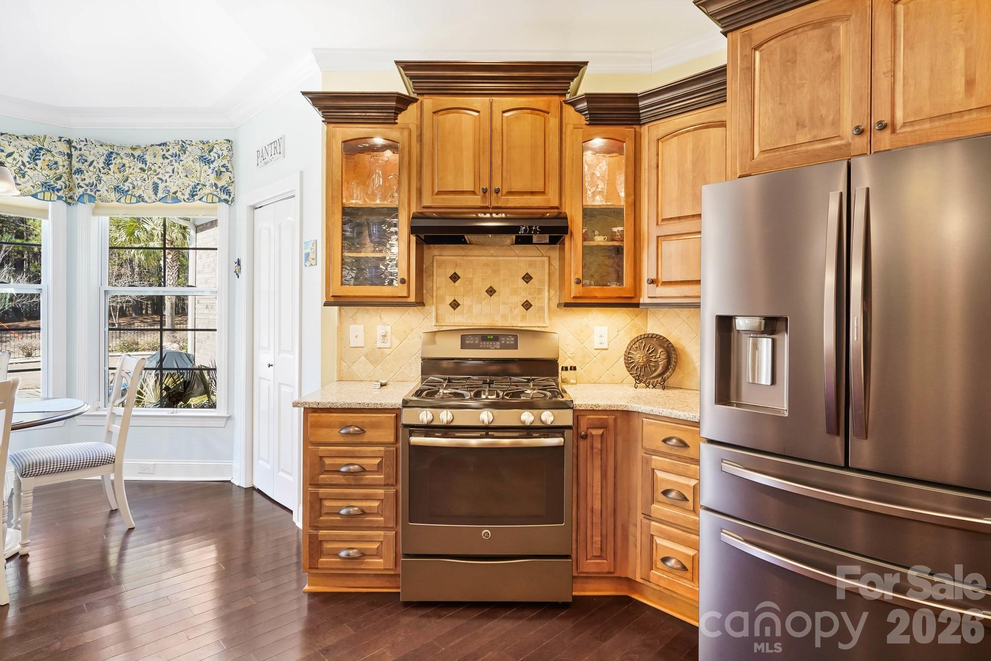 5312 Johnsons Barn Road York, SC 29745 - Photo 21 of 46 a kitchen with granite countertop wooden cabinets and stainless steel appliances