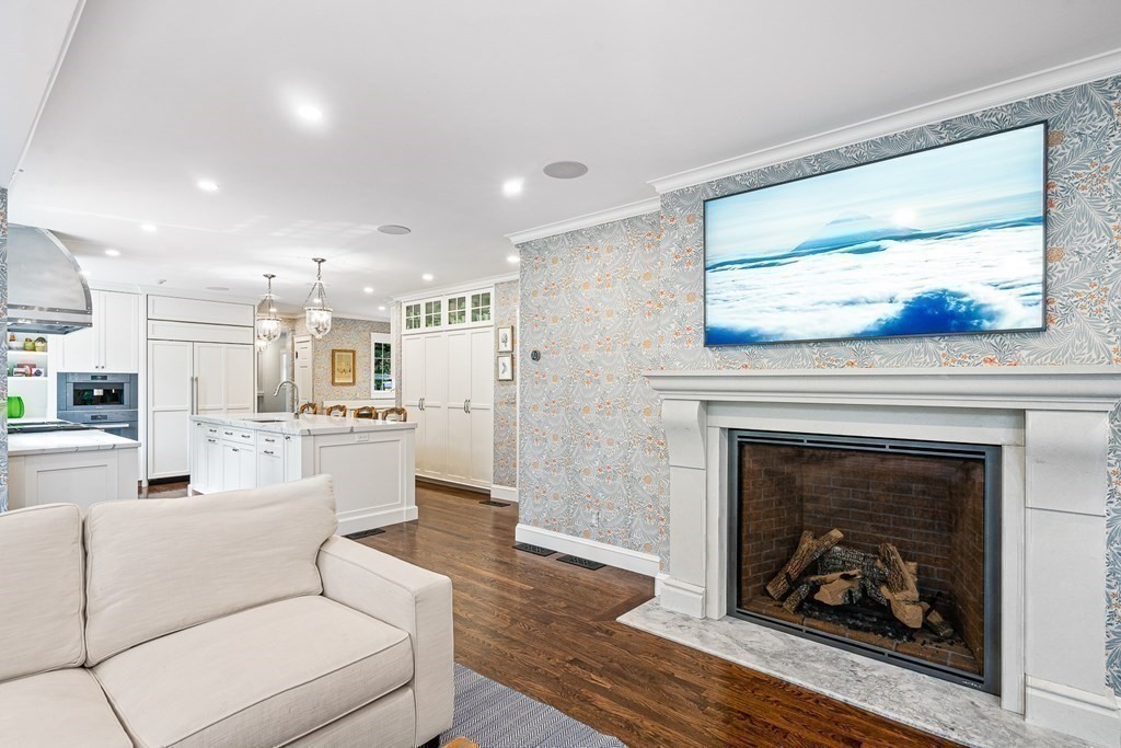 118 Hundreds Road Wellesley, MA 02481 - Photo 12 of 35 a living room with furniture a fireplace and kitchen view
