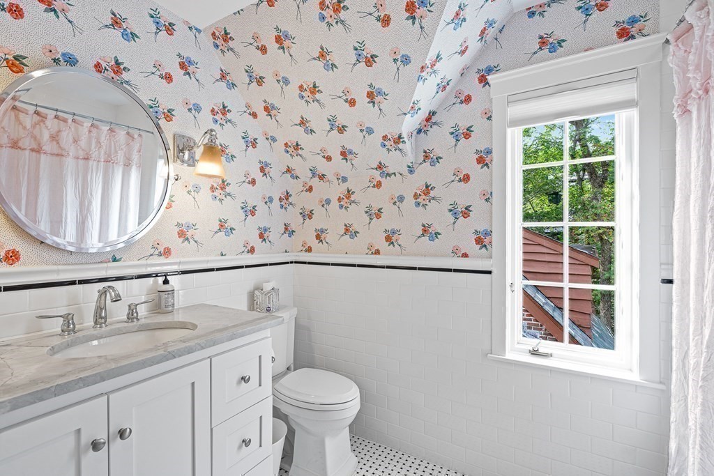 118 Hundreds Road Wellesley, MA 02481 - Photo 27 of 35 a bathroom with a granite countertop sink a toilet and a mirror