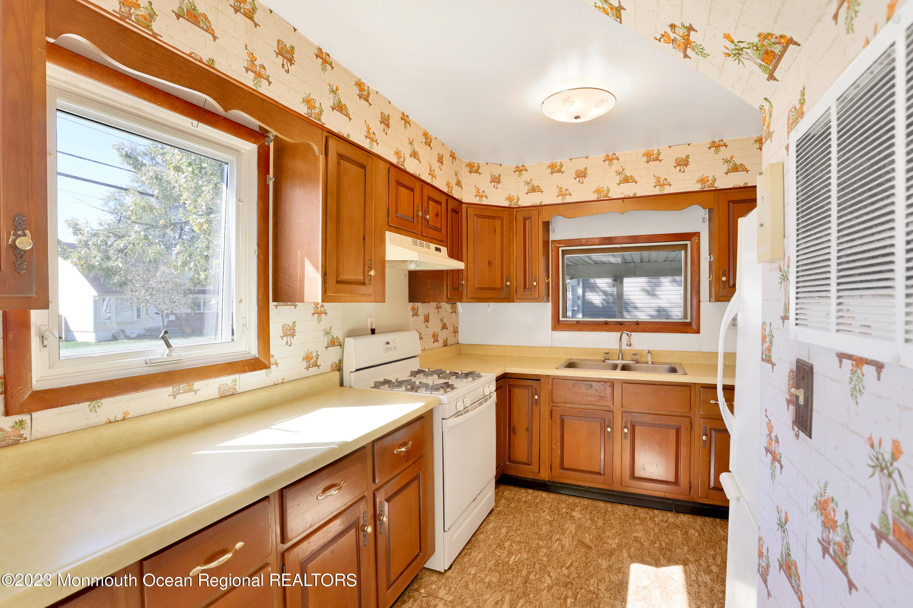 13 Scholer Drive Union Beach, NJ 07735 - Photo 9 of 30 a kitchen with a sink stove and cabinets