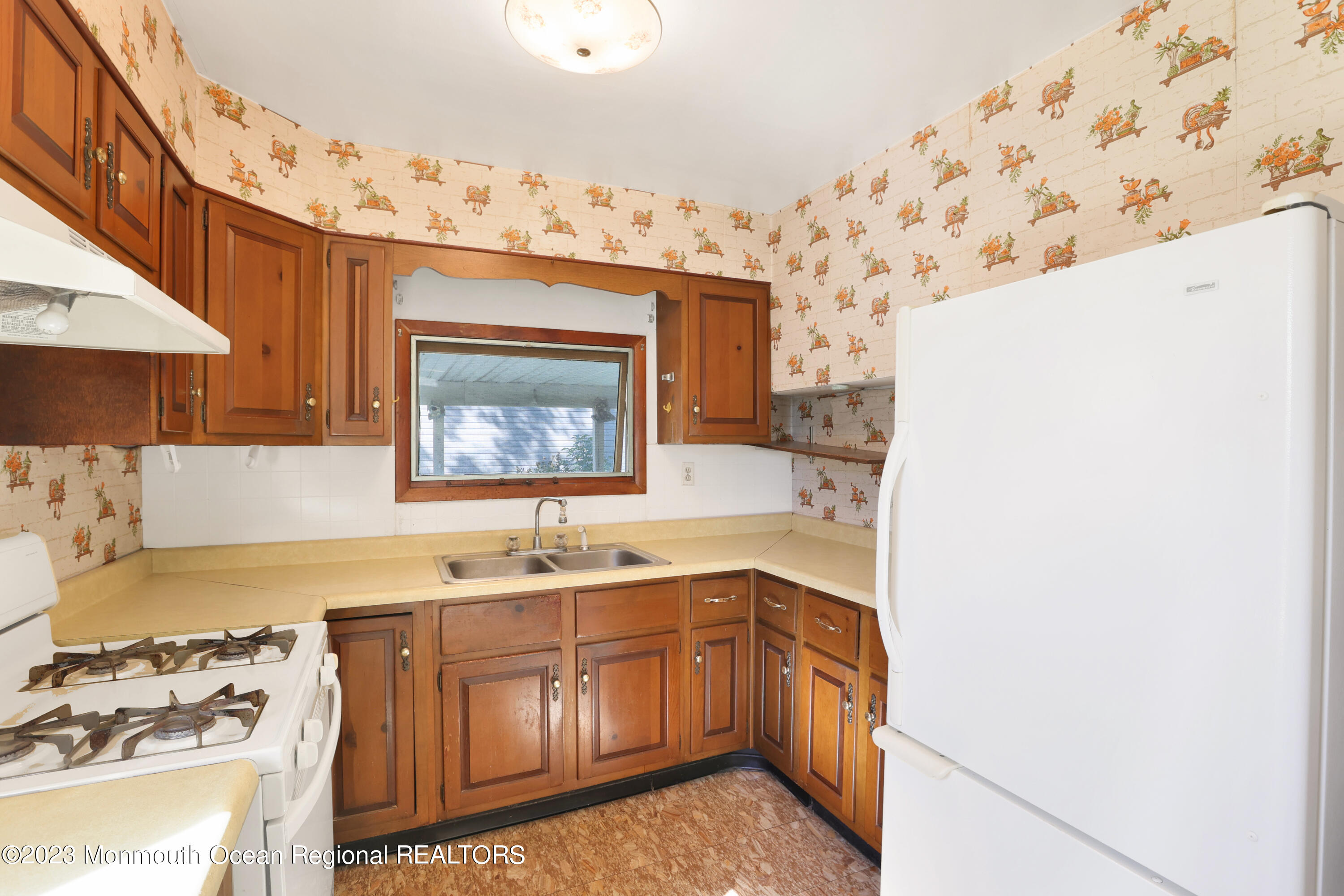 13 Scholer Drive Union Beach, NJ 07735 - Photo 10 of 30 a kitchen with stainless steel appliances granite countertop a sink stove and refrigerator