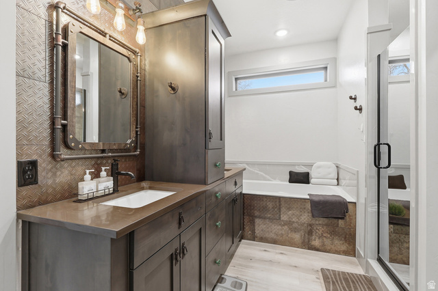175 North 100 West Providence, UT 84332 - Photo 15 of 45 Maser bath with vanity, light wood finished floors, a bath, a stall shower, and recessed lighting