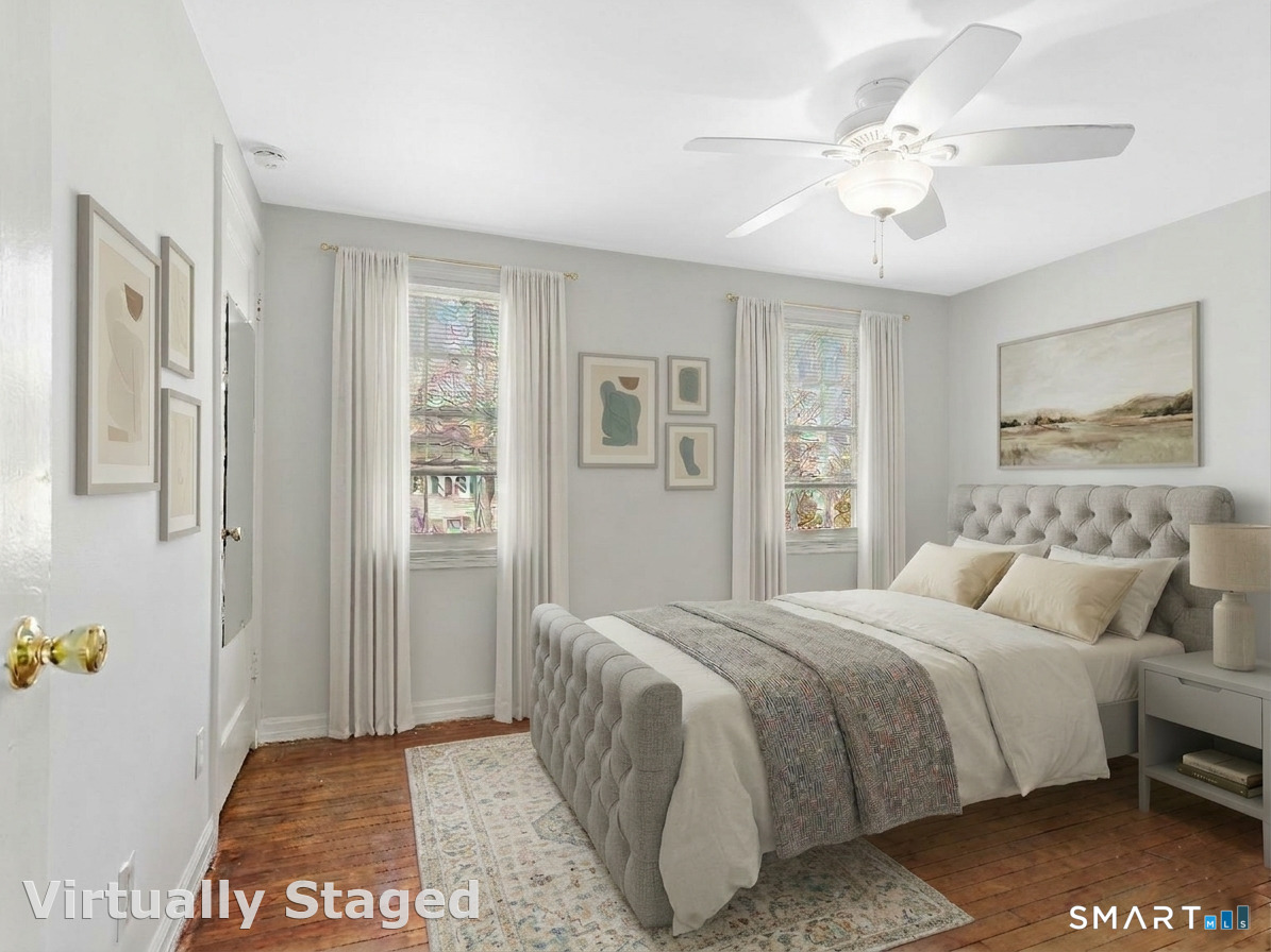 214 Sylvan Knoll Road, Unit 214 Stamford, CT 06902 - Photo 14 of 30 a bedroom with a bed and a chandelier