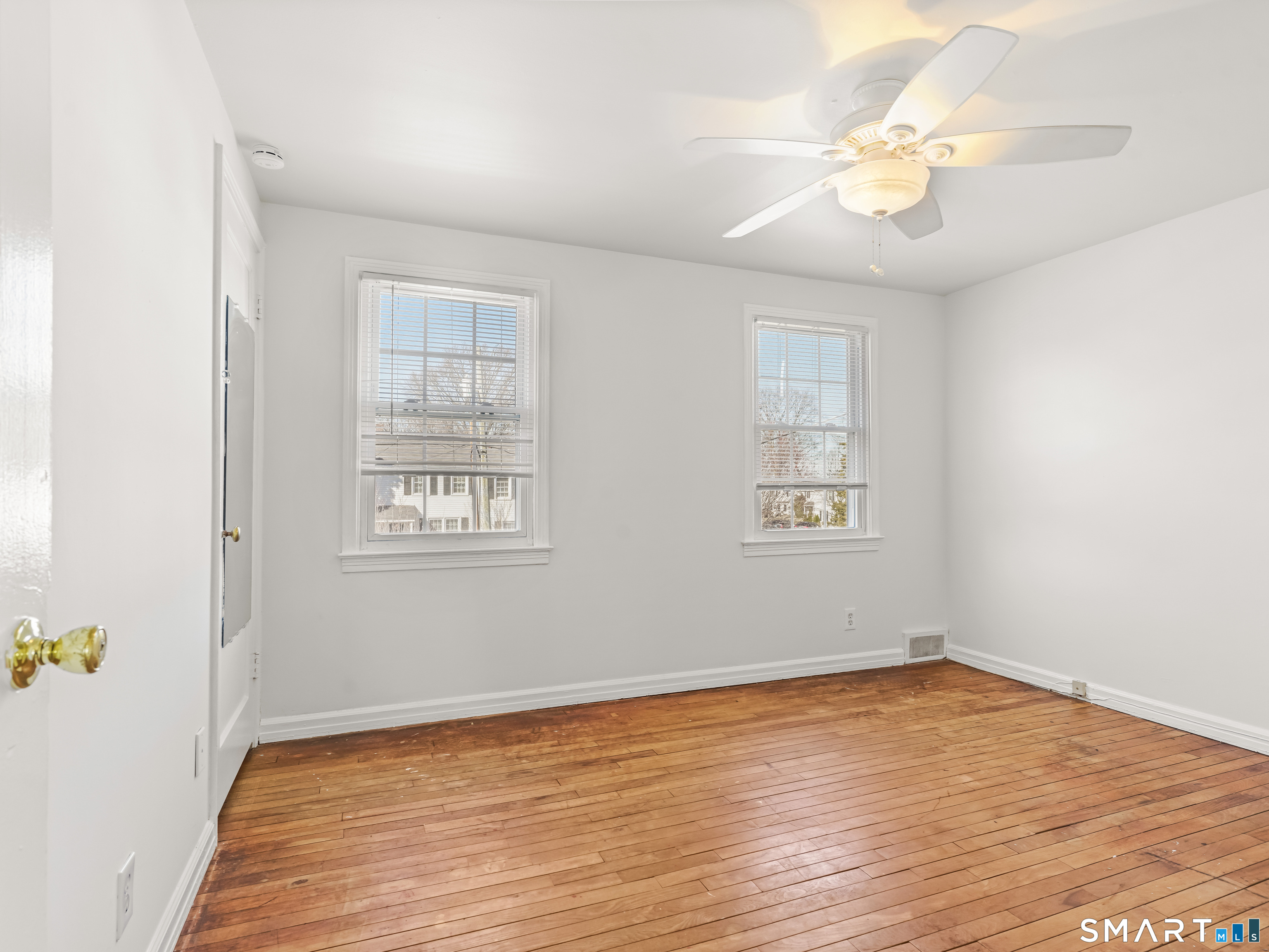 214 Sylvan Knoll Road, Unit 214 Stamford, CT 06902 - Photo 15 of 30 an empty room with wooden floor and windows