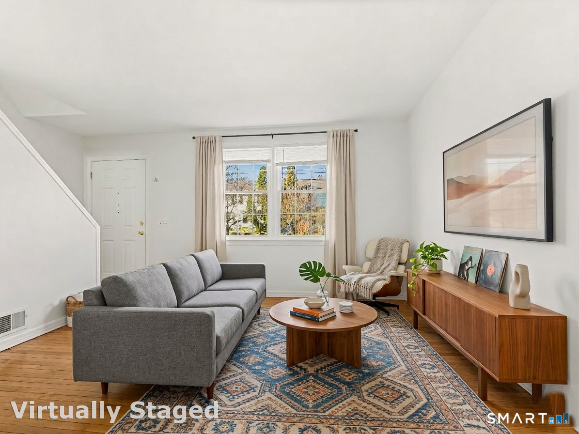 214 Sylvan Knoll Road, Unit 214 Stamford, CT 06902 - Photo 3 of 30 a living room with furniture and a window