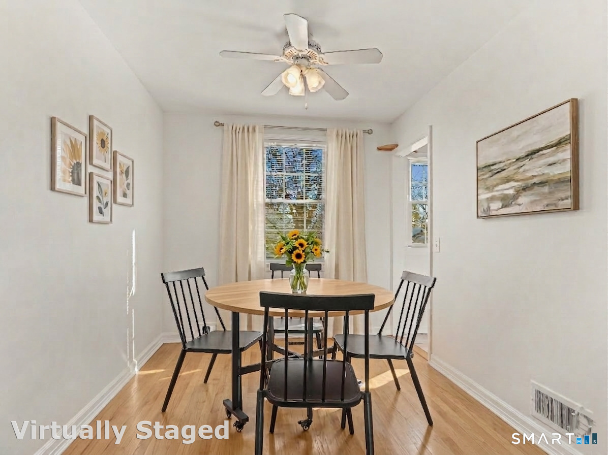 214 Sylvan Knoll Road, Unit 214 Stamford, CT 06902 - Photo 6 of 30 a view of a dining room with furniture window and wooden floor