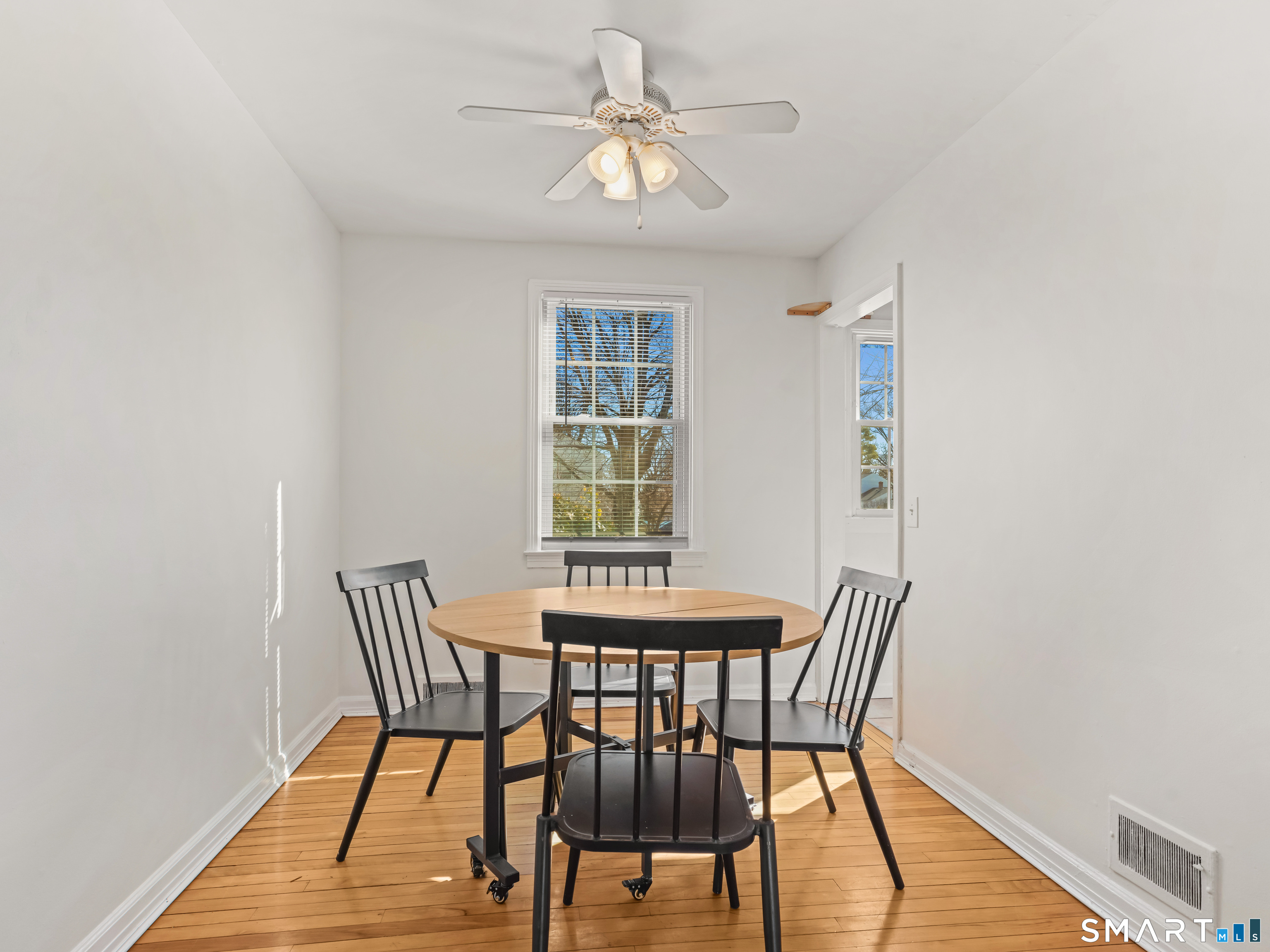 214 Sylvan Knoll Road, Unit 214 Stamford, CT 06902 - Photo 7 of 30 a view of a dining room with furniture window and wooden floor