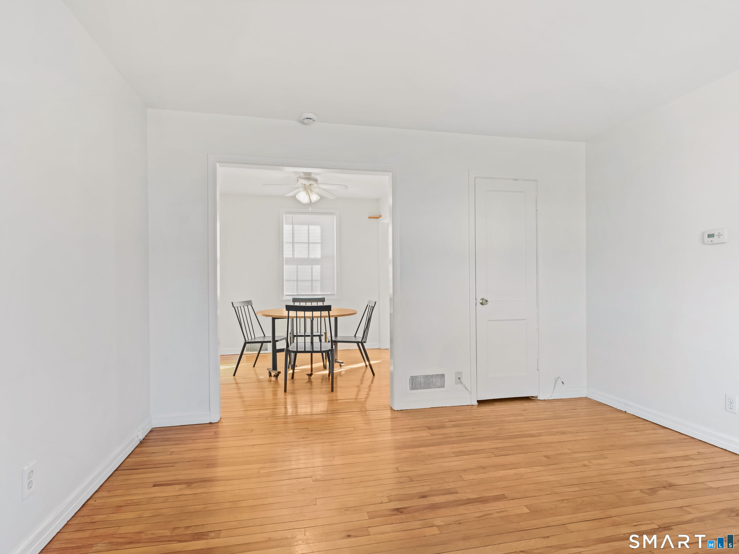 214 Sylvan Knoll Road, Unit 214 Stamford, CT 06902 - Photo 8 of 30 a view of empty room with wooden floor and bench