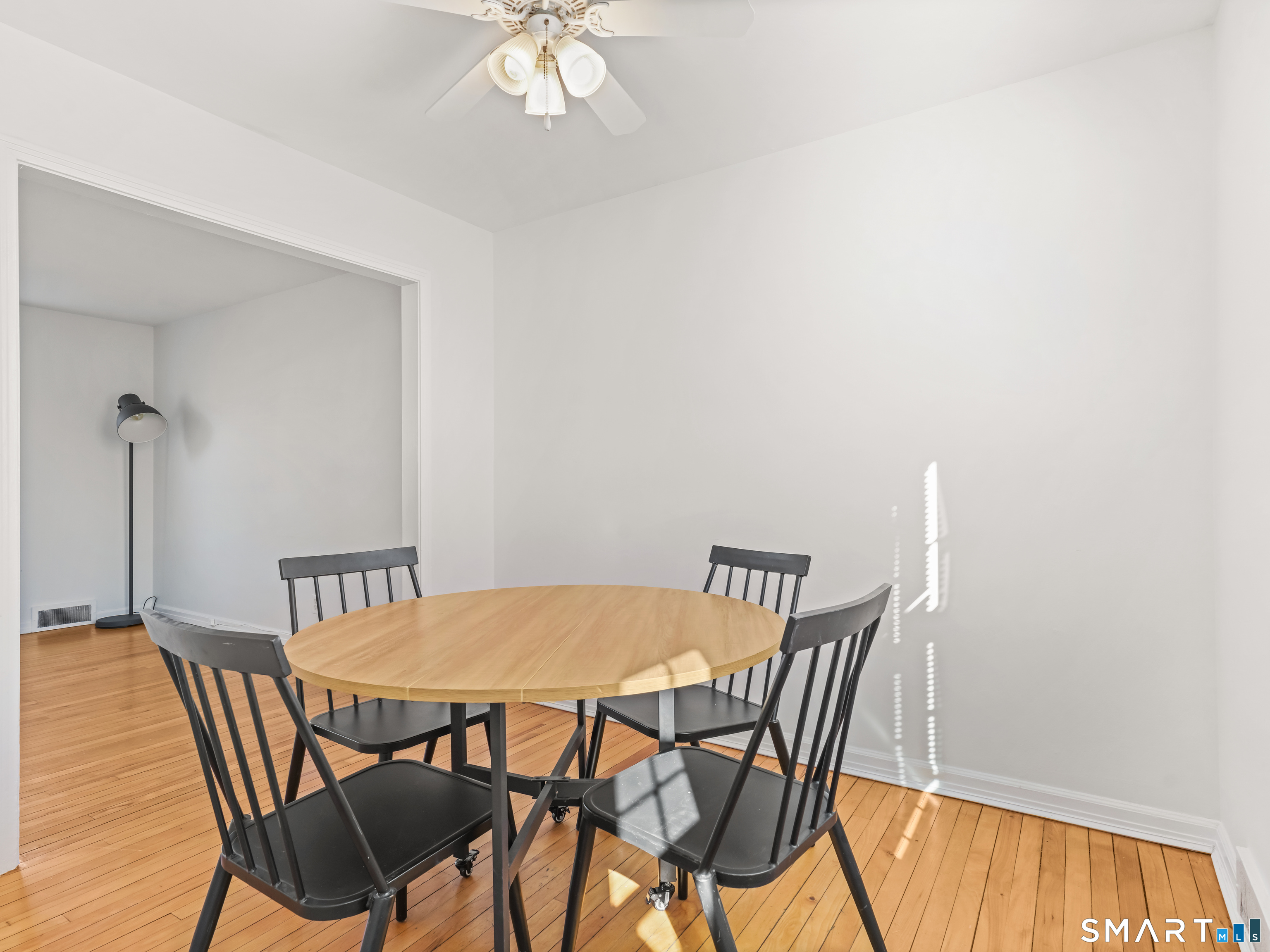 214 Sylvan Knoll Road, Unit 214 Stamford, CT 06902 - Photo 9 of 30 a view of a dining room with furniture and wooden floor