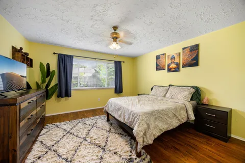 a bedroom with a bed and a flat screen tv