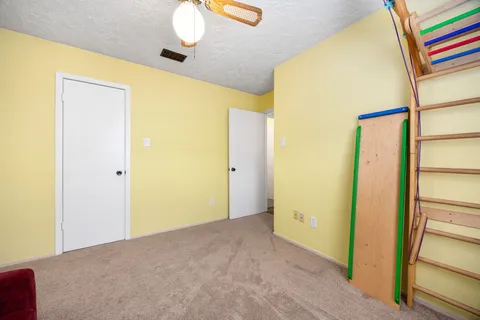 a view of a work space with furniture and a ceiling fan