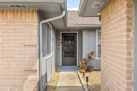a view of a brick house with an outdoor space