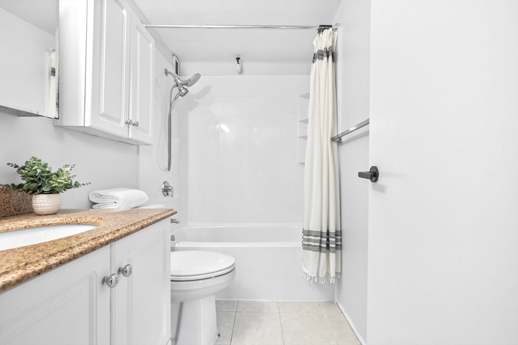 42 8th Street, Unit 1301 Boston, MA 02129 - Photo 11 of 23 a bathroom with a granite countertop sink toilet and shower