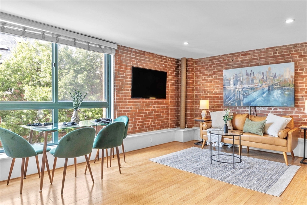 42 8th Street, Unit 1301 Boston, MA 02129 - Photo 5 of 23 a living room with furniture and a flat screen tv