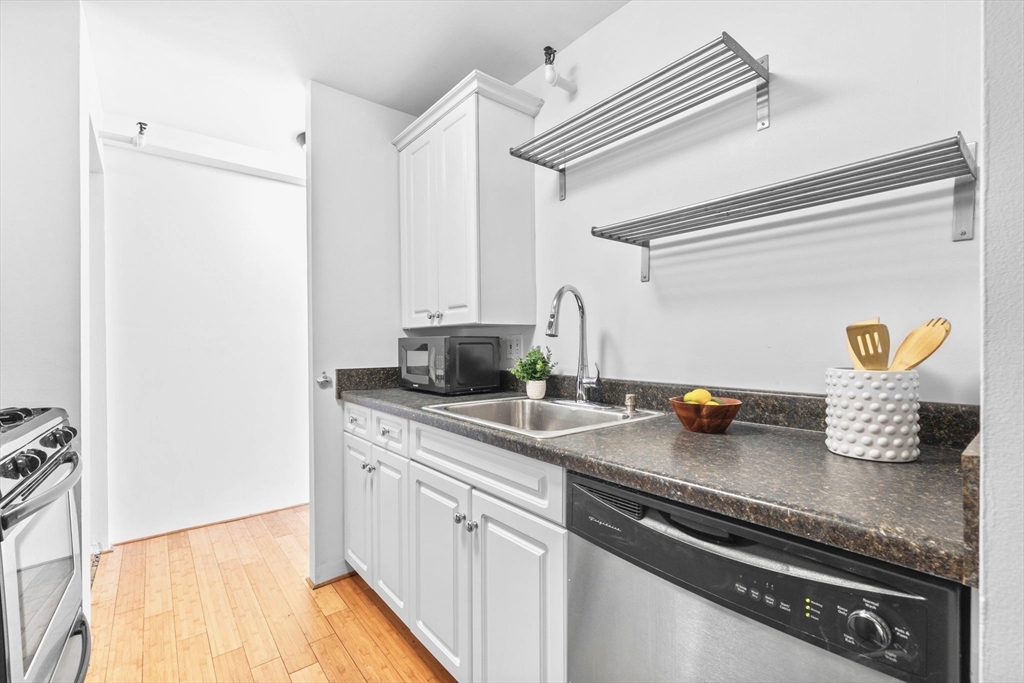 42 8th Street, Unit 1301 Boston, MA 02129 - Photo 7 of 23 a kitchen with a sink appliances and cabinets