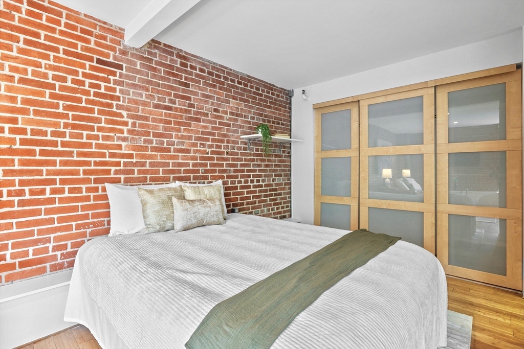 42 8th Street, Unit 1301 Boston, MA 02129 - Photo 8 of 23 a bedroom with a bed and a large window