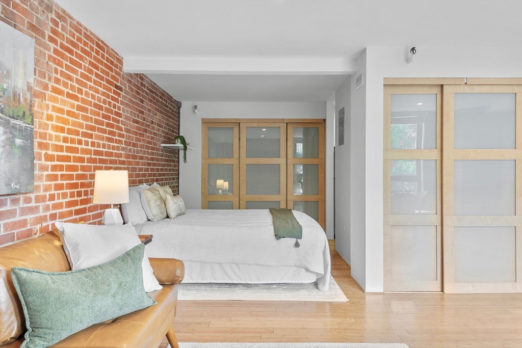 42 8th Street, Unit 1301 Boston, MA 02129 - Photo 9 of 23 a bedroom with furniture and windows