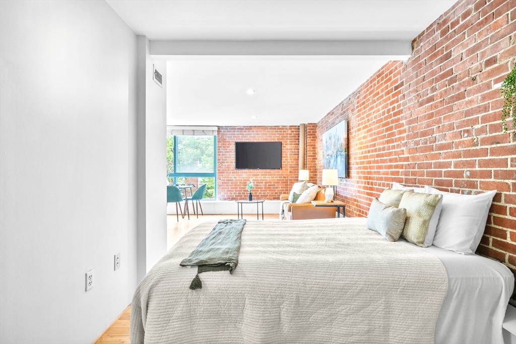 42 8th Street, Unit 1301 Boston, MA 02129 - Photo 10 of 23 a bedroom with a bed and large window