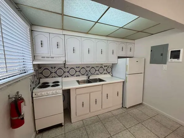 a view of a kitchen with electric appliances