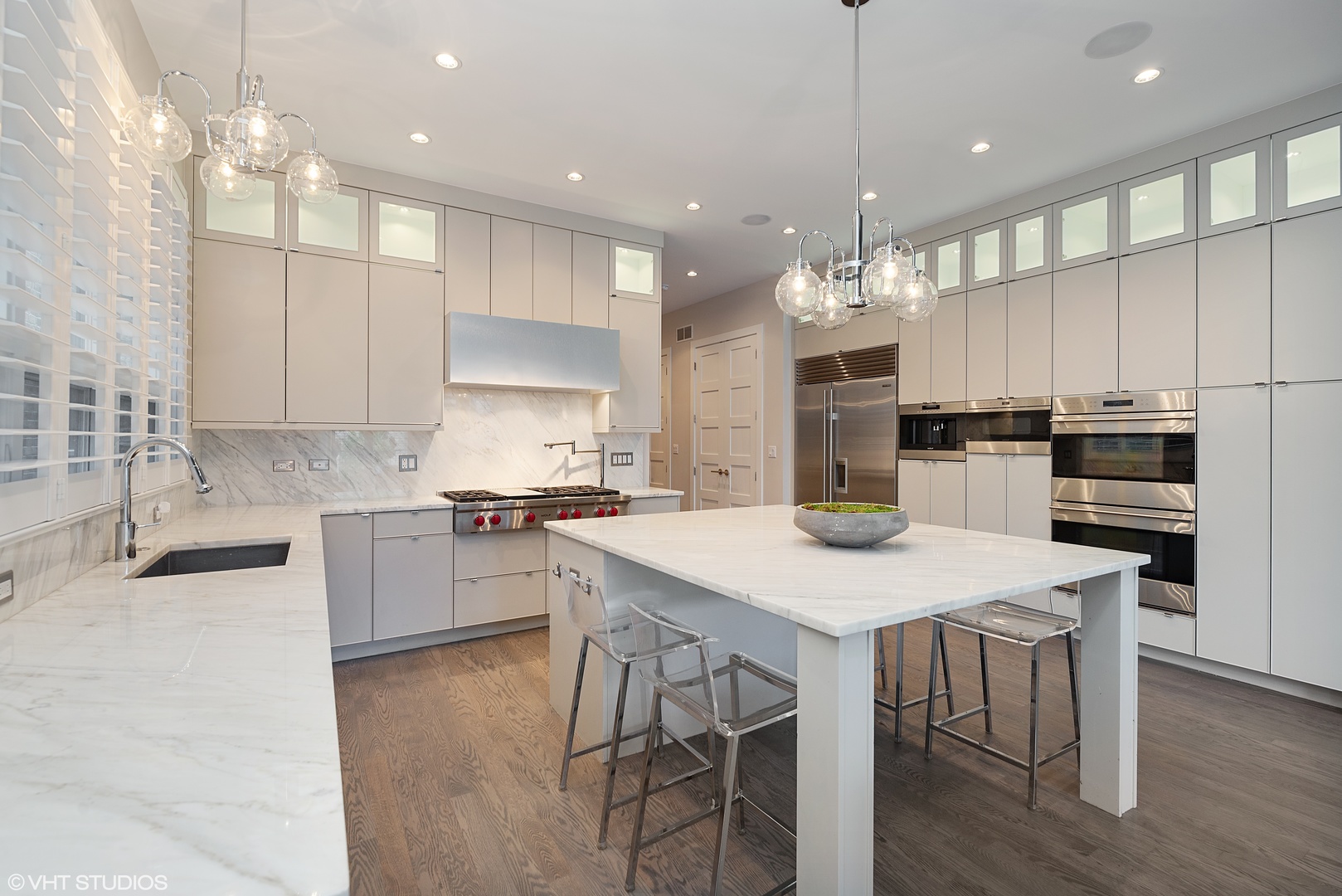 1428 West Wolfram Street Chicago, IL 60657 - Photo 11 of 47 a kitchen with kitchen island a stove a table and chairs in it