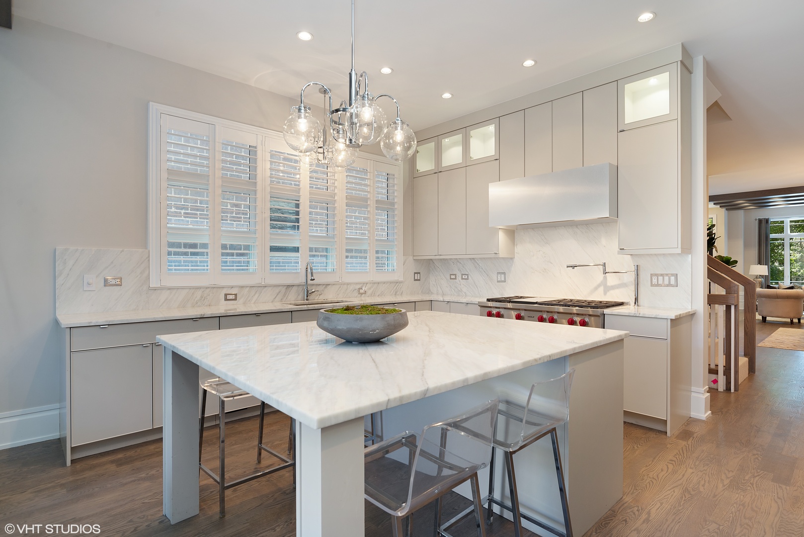 1428 West Wolfram Street Chicago, IL 60657 - Photo 10 of 47 a kitchen with a stove a kitchen island and chairs in it