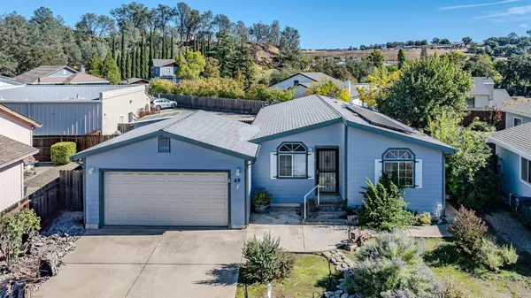 a house that has a tree in front of it