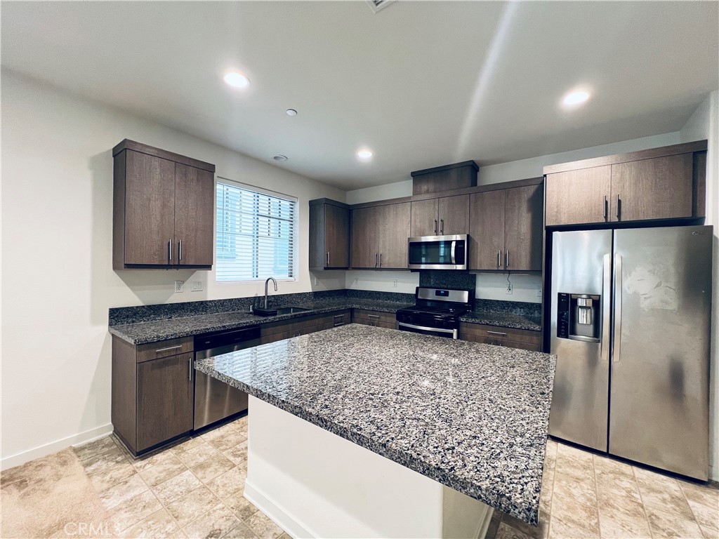 566 Boulder Circle Claremont, CA 91711 - Photo 8 of 12 a kitchen with stainless steel appliances granite countertop a sink stove and refrigerator