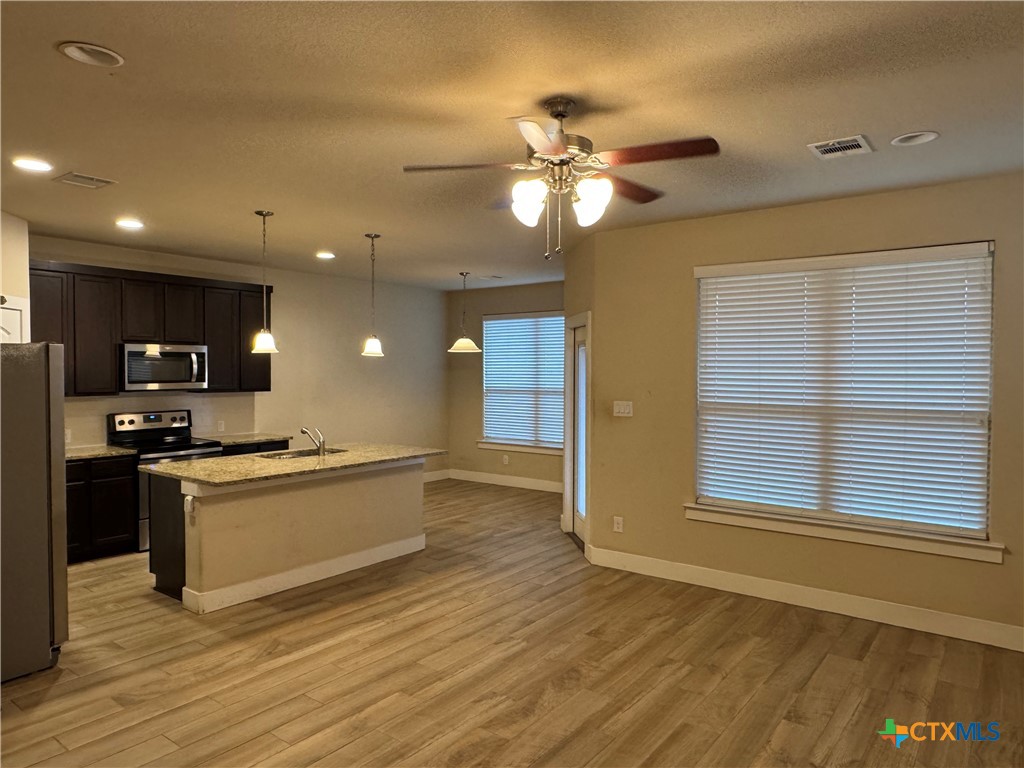523 High Tech Drive Georgetown, TX 78626 - Photo 2 of 11 a kitchen with stainless steel appliances granite countertop a sink and a stove