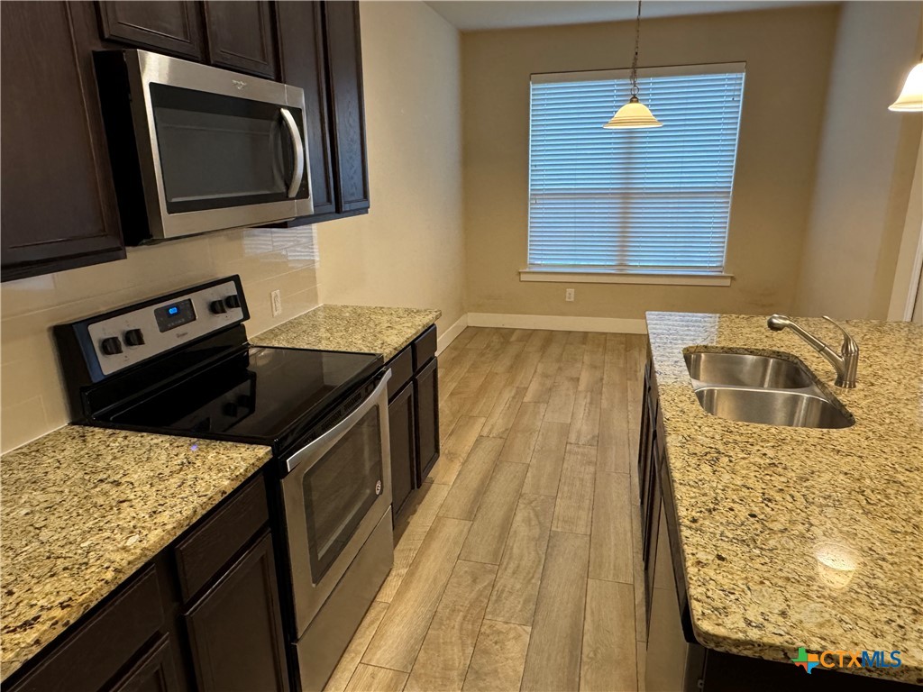 523 High Tech Drive Georgetown, TX 78626 - Photo 4 of 11 a kitchen with a stove and a sink
