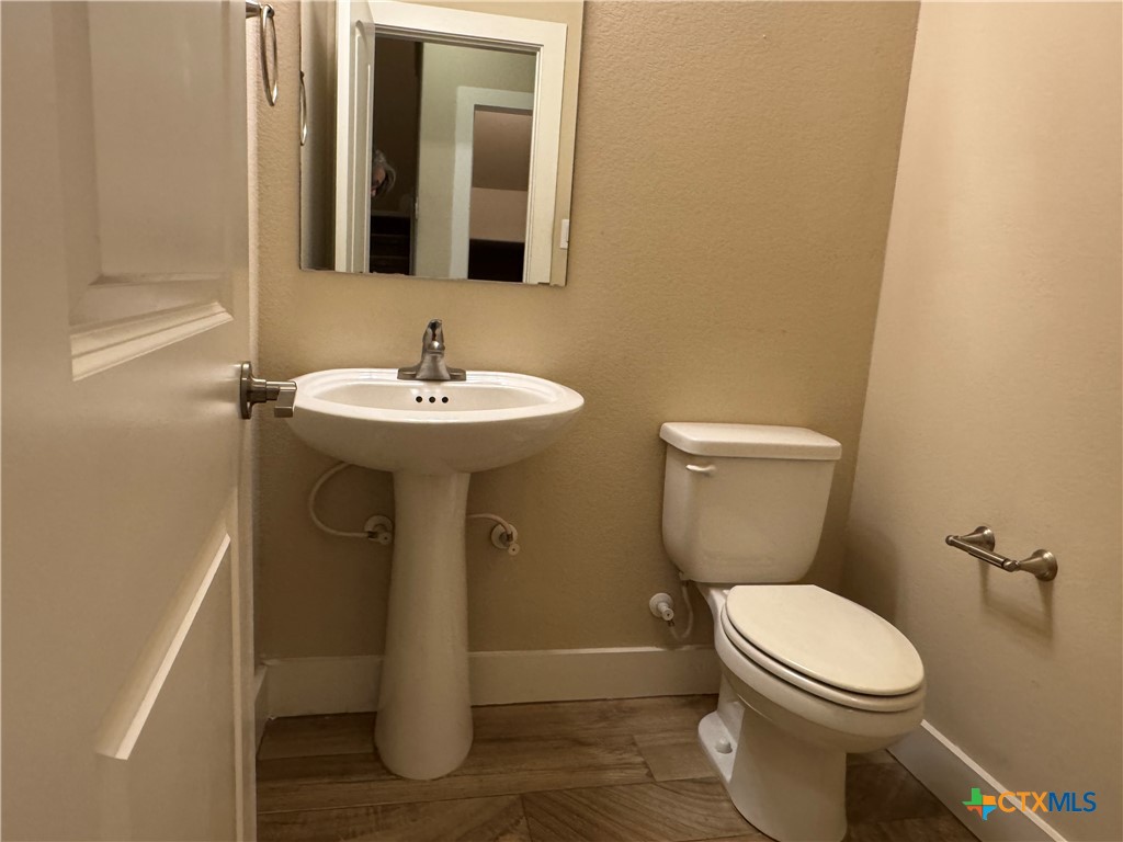 523 High Tech Drive Georgetown, TX 78626 - Photo 5 of 11 a bathroom with a sink and a toilet