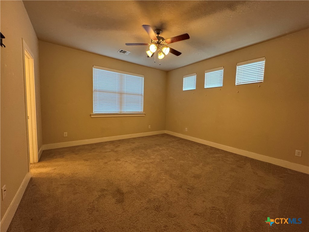 523 High Tech Drive Georgetown, TX 78626 - Photo 6 of 11 a view of a livingroom with a ceiling fan and window
