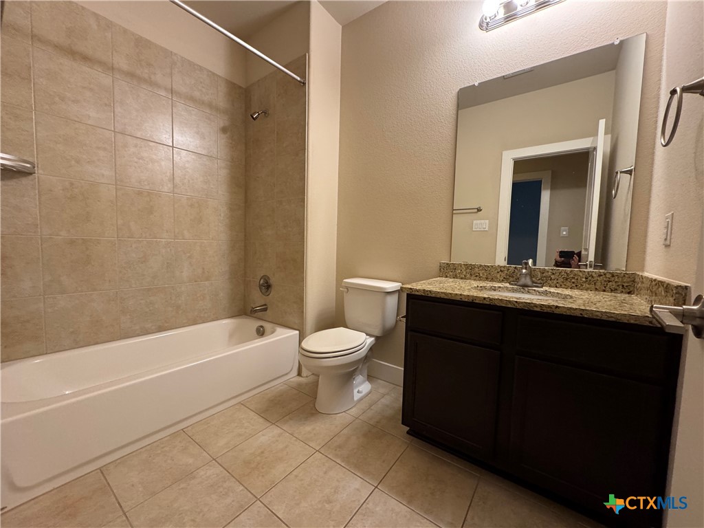 523 High Tech Drive Georgetown, TX 78626 - Photo 10 of 11 a bathroom with a bathtub sink vanity mirror and toilet