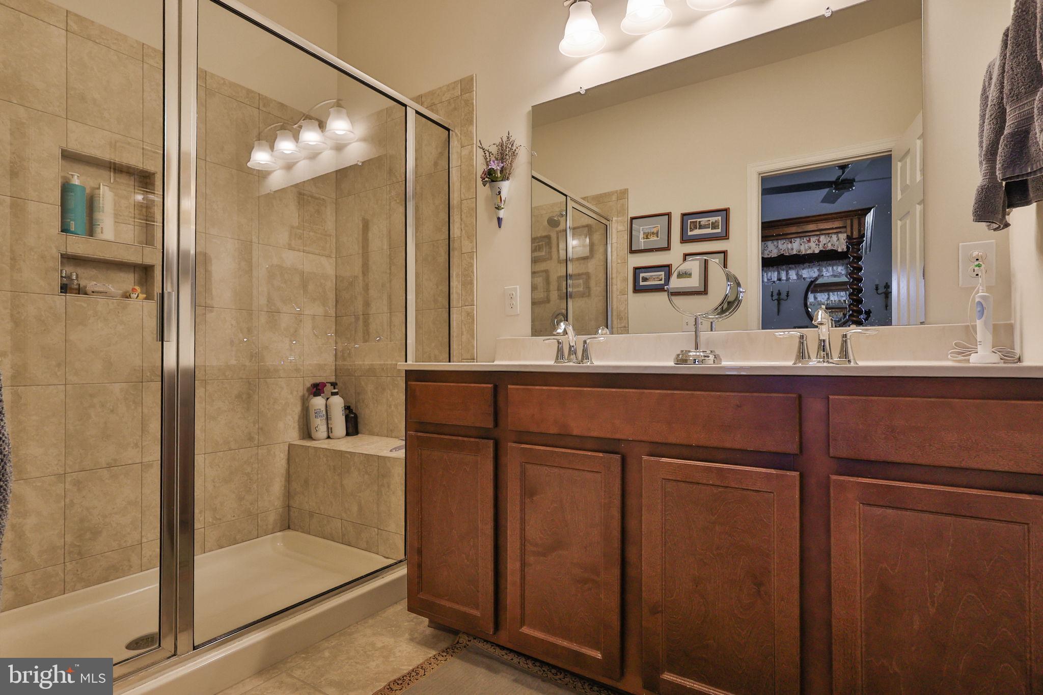 3872 Mink Road Emmaus, PA 18049 - Photo 19 of 39 a bathroom with a shower sink and mirror