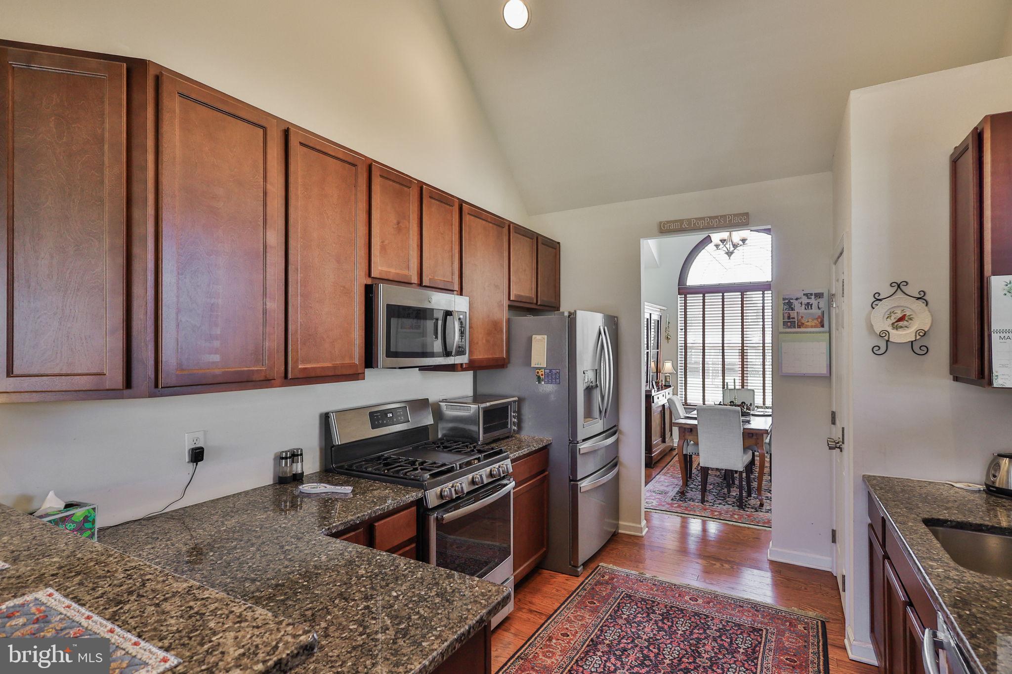 3872 Mink Road Emmaus, PA 18049 - Photo 8 of 39 a kitchen with stainless steel appliances granite countertop a stove top oven a sink dishwasher a refrigerator and cabinets with wooden floor