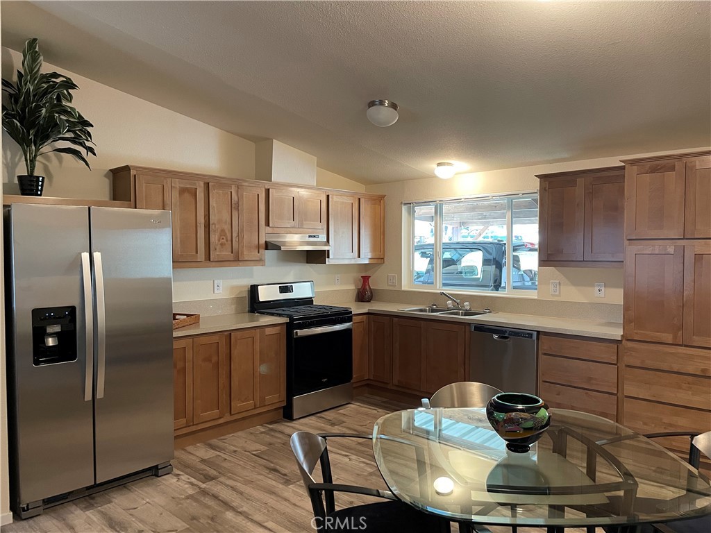 1340 Bille Road, Unit 13 Paradise, CA 95969 - Photo 11 of 31 a kitchen with stainless steel appliances granite countertop a sink dishwasher stove refrigerator and cabinets